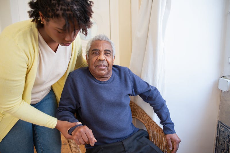 Caregiver providing compassionate support to elderly client at home